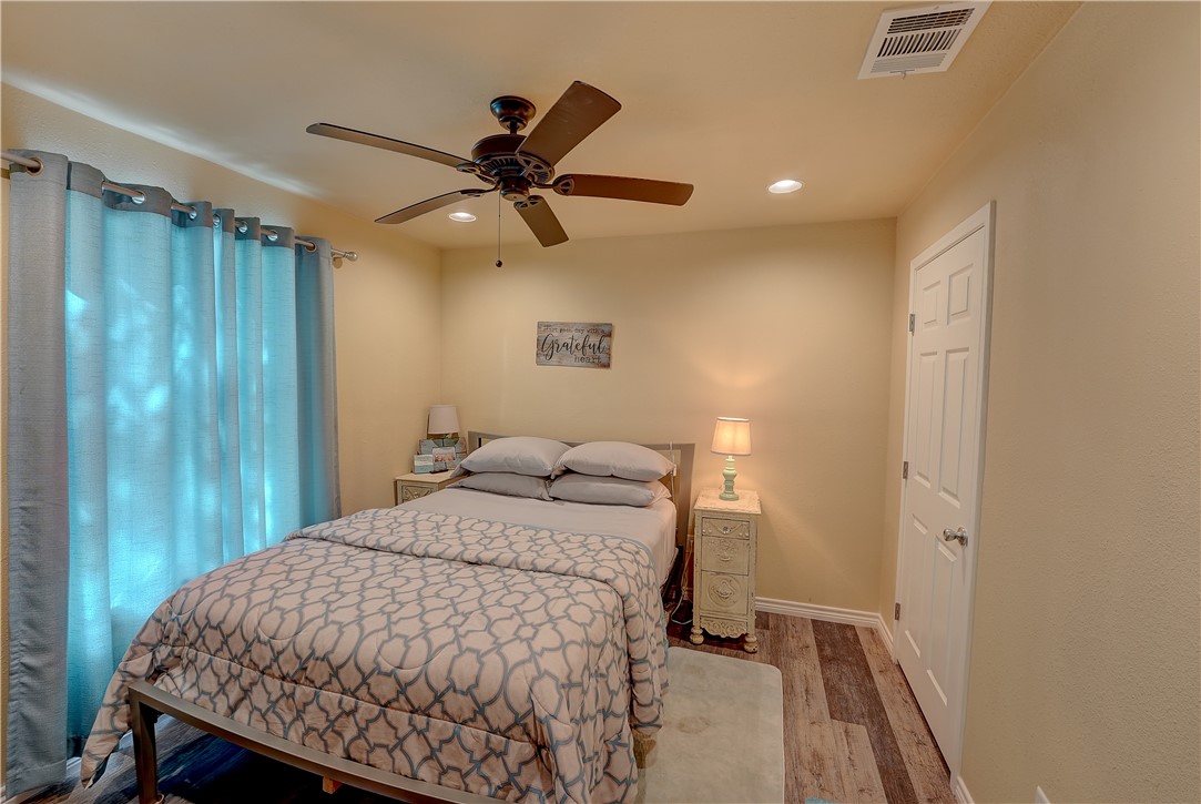 2102 Prairie Road Rockport, TX 78382 - Photo 15 of 26 a bedroom with a bed and a chandelier