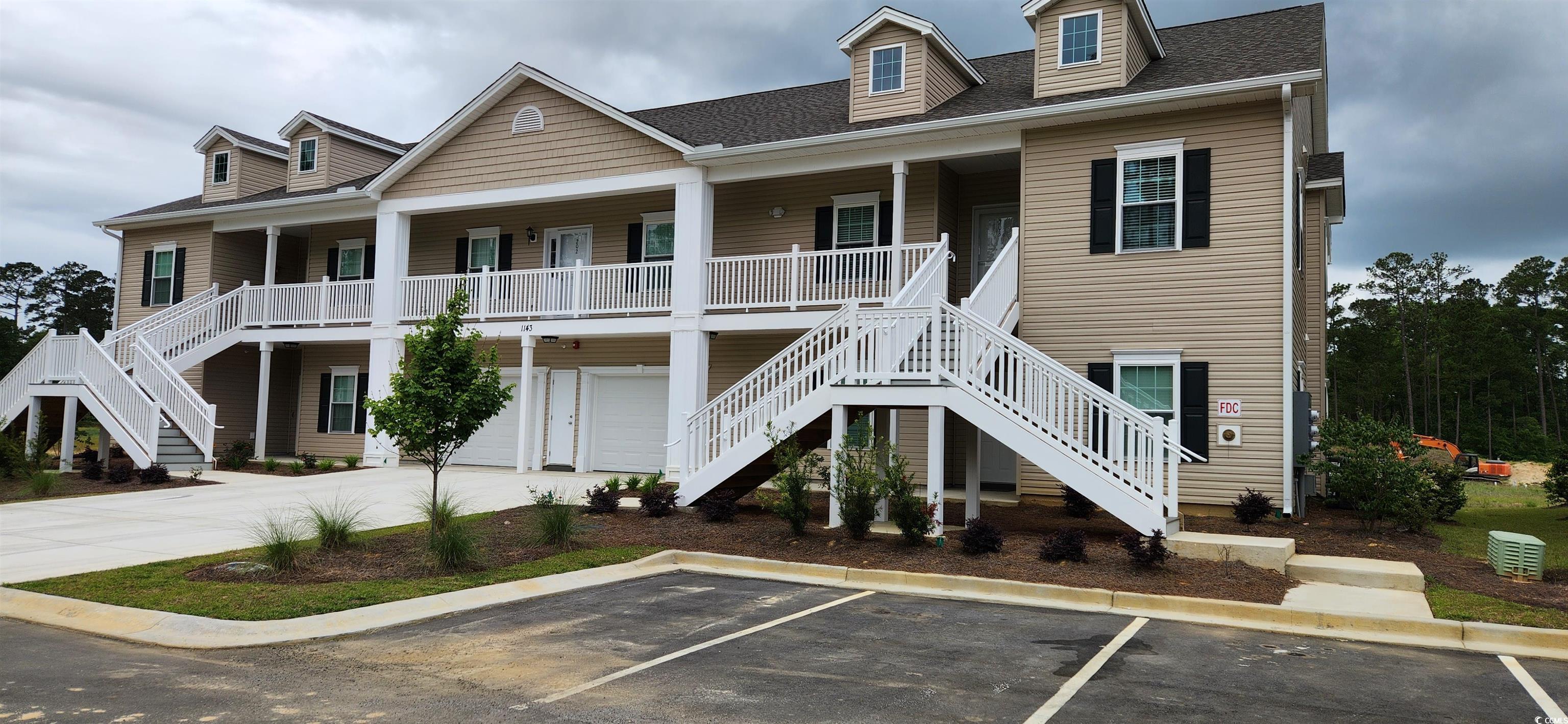 1143 Freeboard Street, Unit 203 Murrells Inlet, SC 29576 - Photo 1 of 35 View of front of property featuring uncovered park