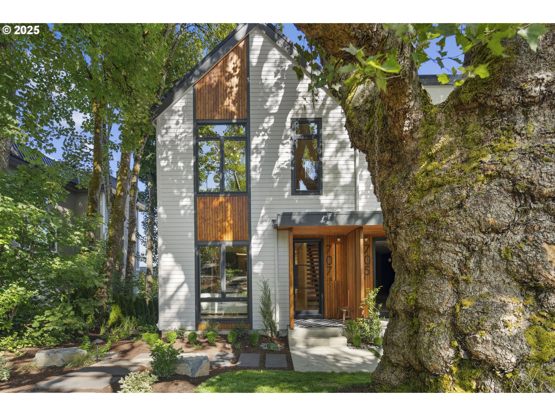 701 1st Street Lake Oswego, OR 97034 - Photo 15 of 42 a view of a brick house with a large windows and plants