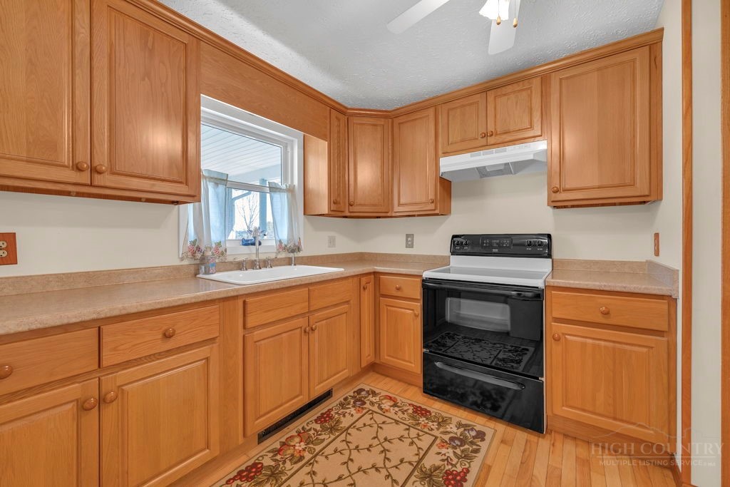 163 Rolling Hill Drive Boone, NC 28607 - Photo 12 of 40 a kitchen with granite countertop a sink cabinets and stainless steel appliances