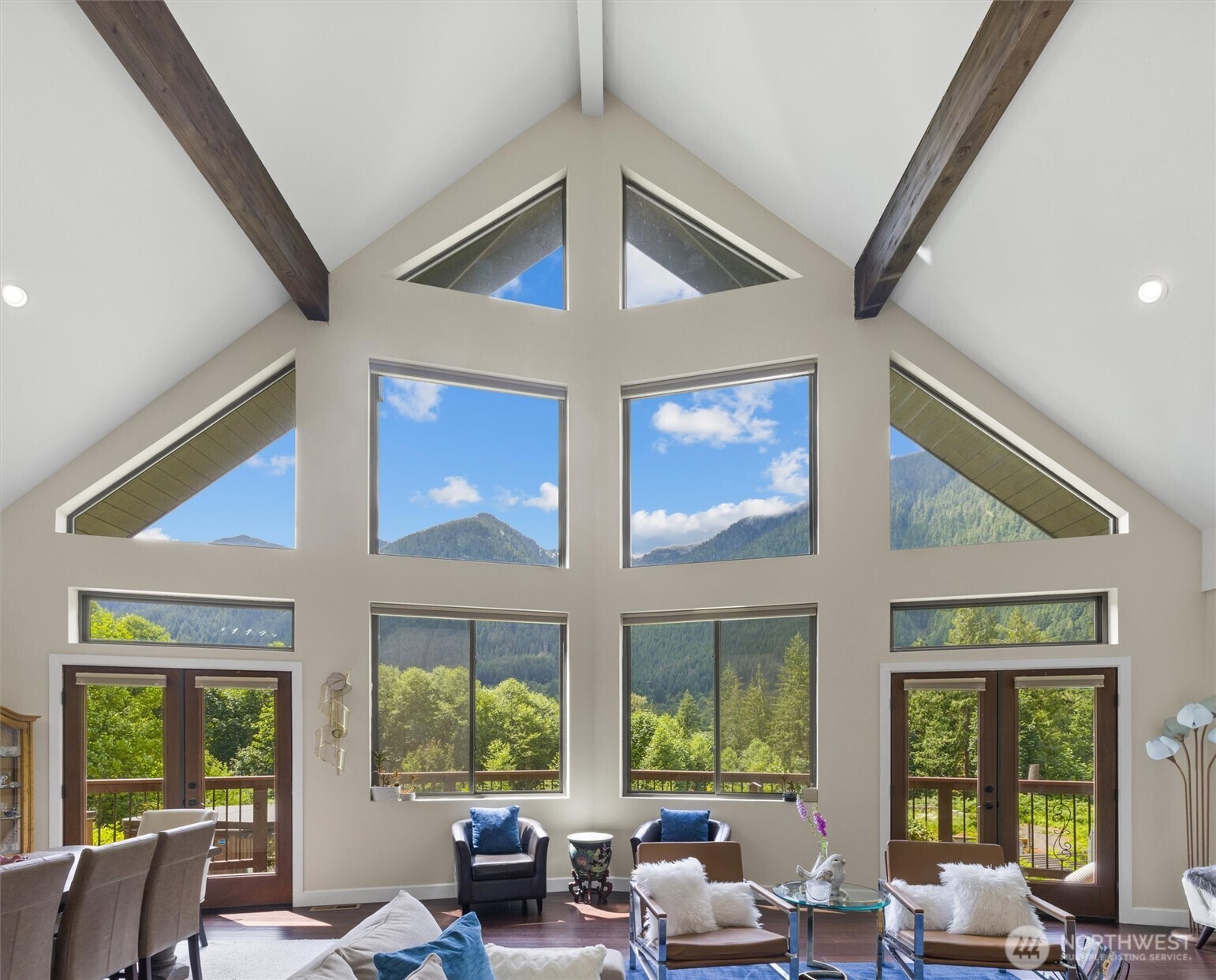 a living room with furniture and large windows