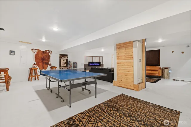 a living room with furniture a flat screen tv and a table