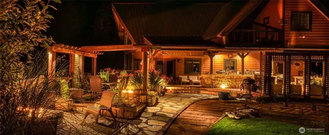 a view of a patio with table and chairs with wooden floor and fence