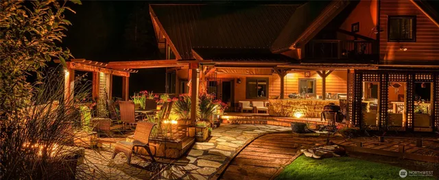 a view of a patio with table and chairs with wooden floor and fence