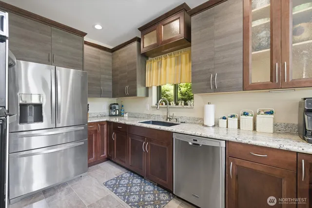 a kitchen with stainless steel appliances granite countertop a sink stove and refrigerator