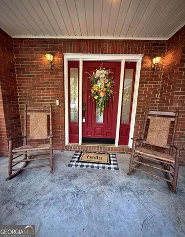 a living room with furniture a window and gym equipment