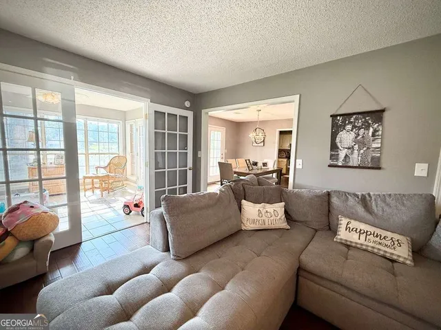a living room with furniture and a floor to ceiling window