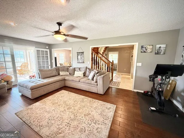 a living room with furniture and a floor to ceiling window