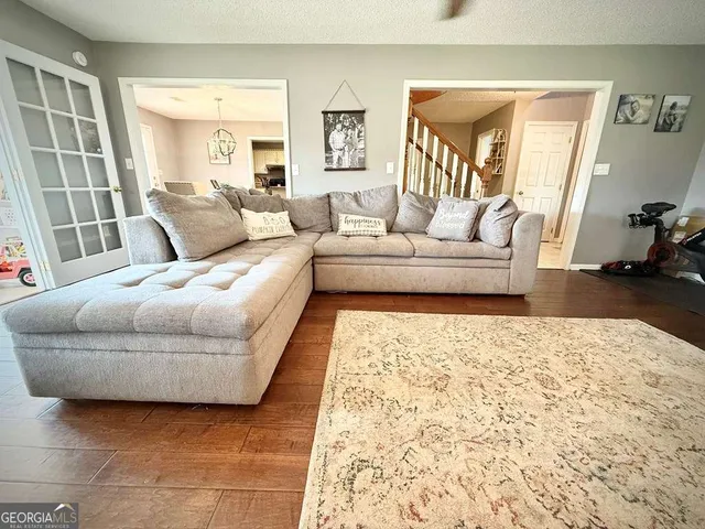 a living room with furniture and large windows