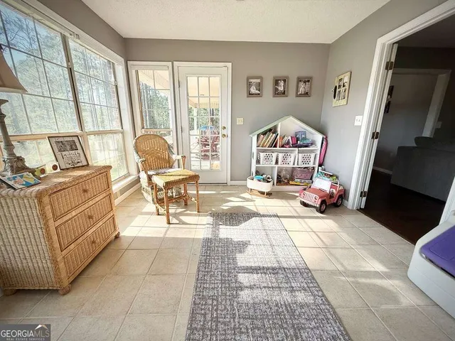 a dining room with furniture a chandelier and wooden floor