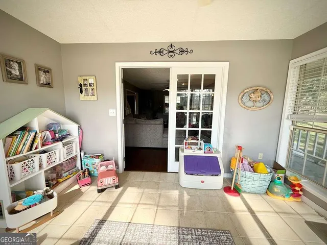 a kitchen with stainless steel appliances granite countertop a table and chairs in it