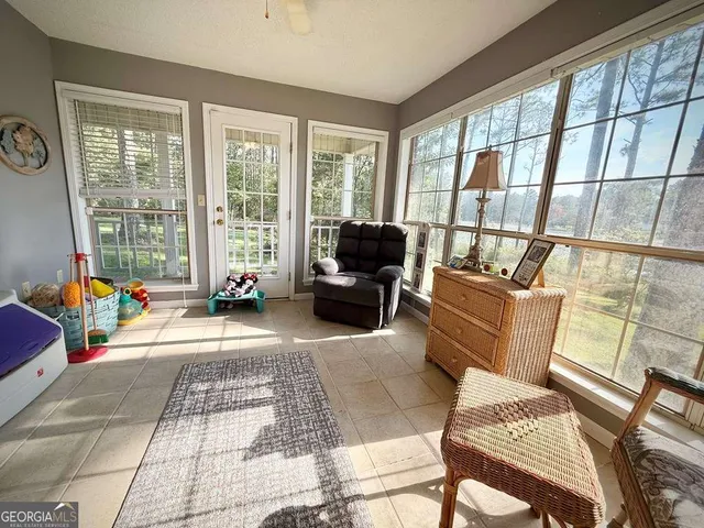 a kitchen with stainless steel appliances granite countertop a sink stove and white cabinets with wooden floor