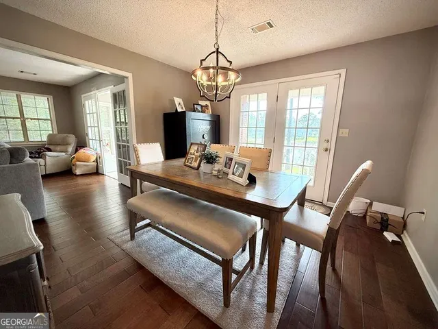 a view of staircase with lots of frames on wall and a rug