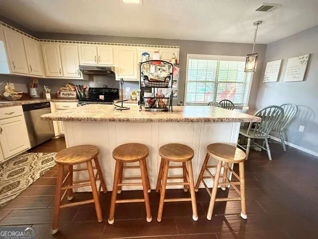 a bedroom with furniture and a mirror