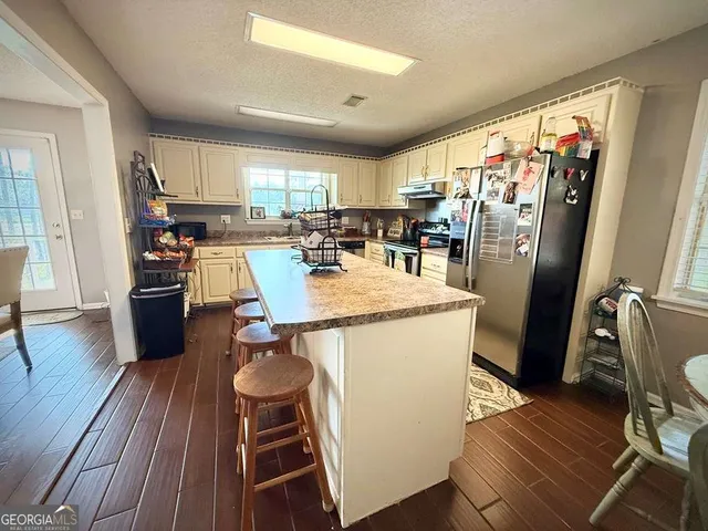 a bedroom with a bed couch and window