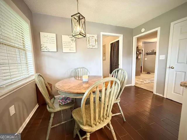 a large white room with a large window and furniture