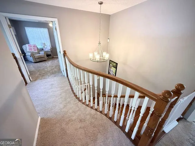 a bedroom with furniture and a flat screen tv