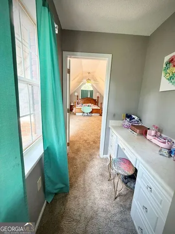 a view of a hallway with wooden floor and dining room