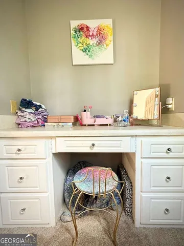 a bedroom with furniture and a chandelier fan
