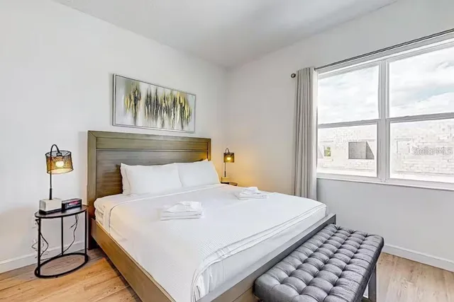 a bedroom with a bed and window