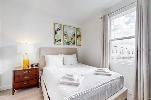 a bedroom with a bed and a window