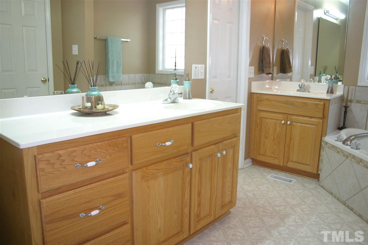 419 Rosa Circle Willow Spring, NC 27592 - Photo 8 of 25 a bathroom with a double vanity sink mirror and toilet