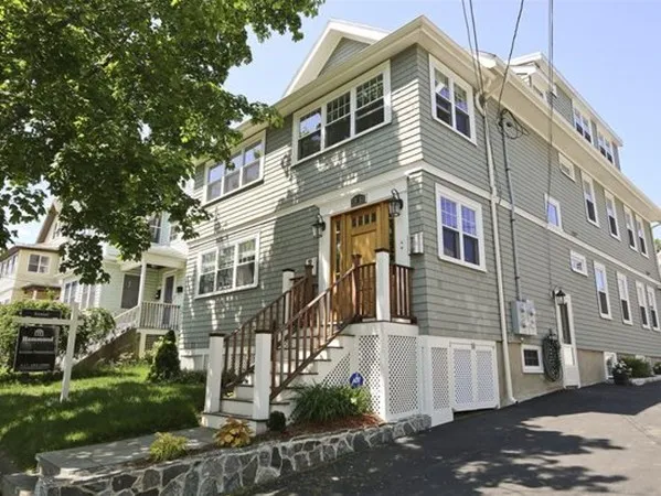 a front view of a residential apartment building with a yard