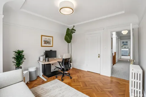 a very nice looking room with a large window and furniture