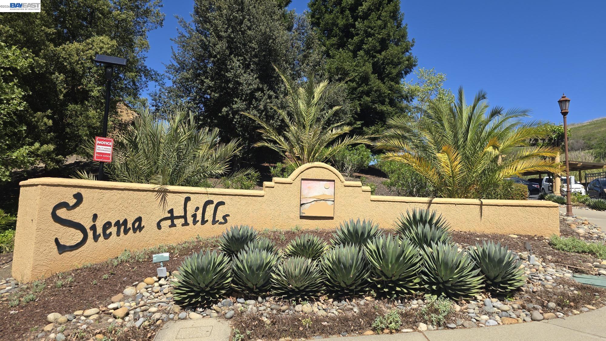735 Watson Canyon Court, Unit 218 San Ramon, CA 94582 - Photo 18 of 26 a view of outdoor space with signage and flags