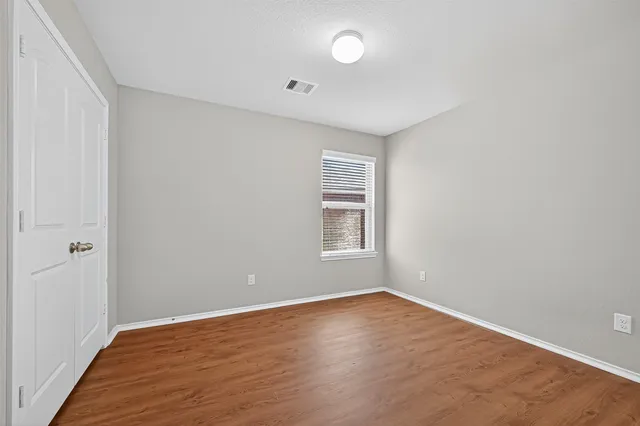 a view of a room with wooden floor and window