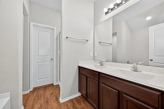 a bathroom with a sink double vanity and a mirror