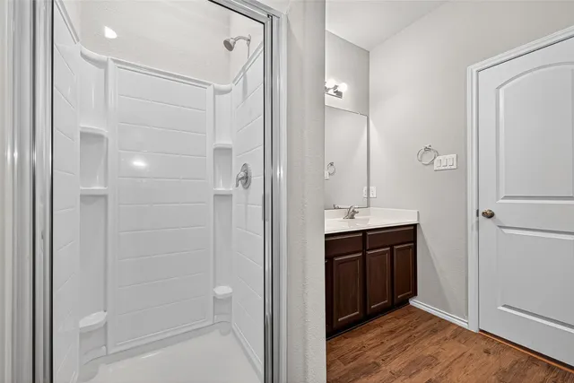 a bathroom with a shower and a sink