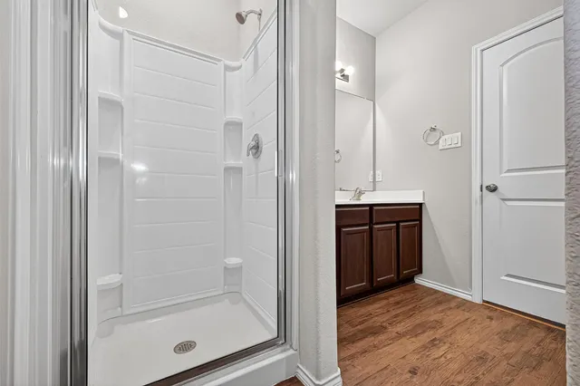 a bathroom with a shower and a sink