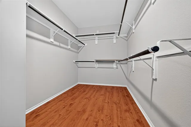 a view of a room with wooden floor