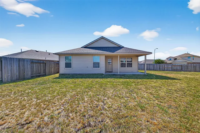a view of a house with a backyard and a garden