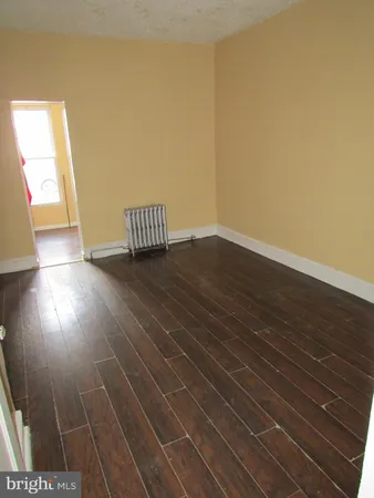 a view of wooden floor and windows in a room