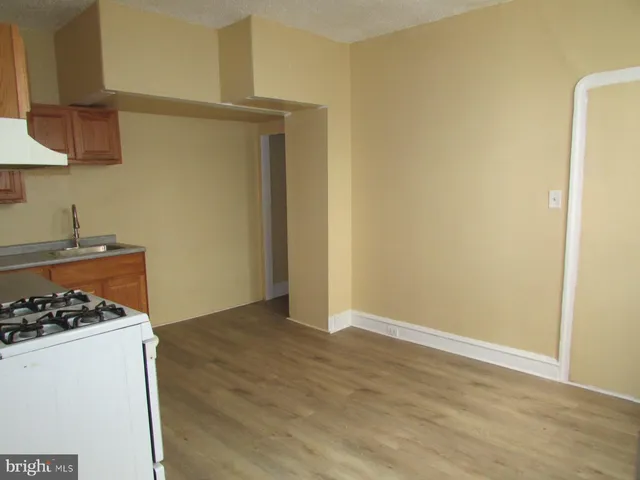 a view of a storage and utility room with wooden floor
