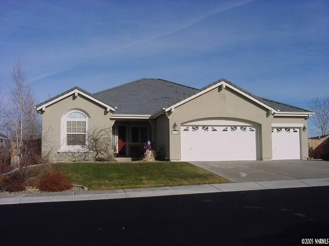 1774 Braidwood Drive Sparks, NV 89436 - Photo 1 of 9 a view of a house with a yard and large trees