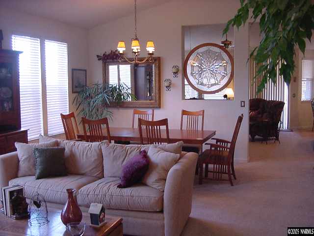 1774 Braidwood Drive Sparks, NV 89436 - Photo 4 of 9 a living room with furniture a large window and a clock