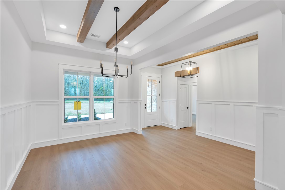 4554 Flat Rock Road Iva, SC 29655 - Photo 15 of 32 Exposed wood beams adorn the high ceilings, creating a rustic yet refined atmosphere in this spacious interior.