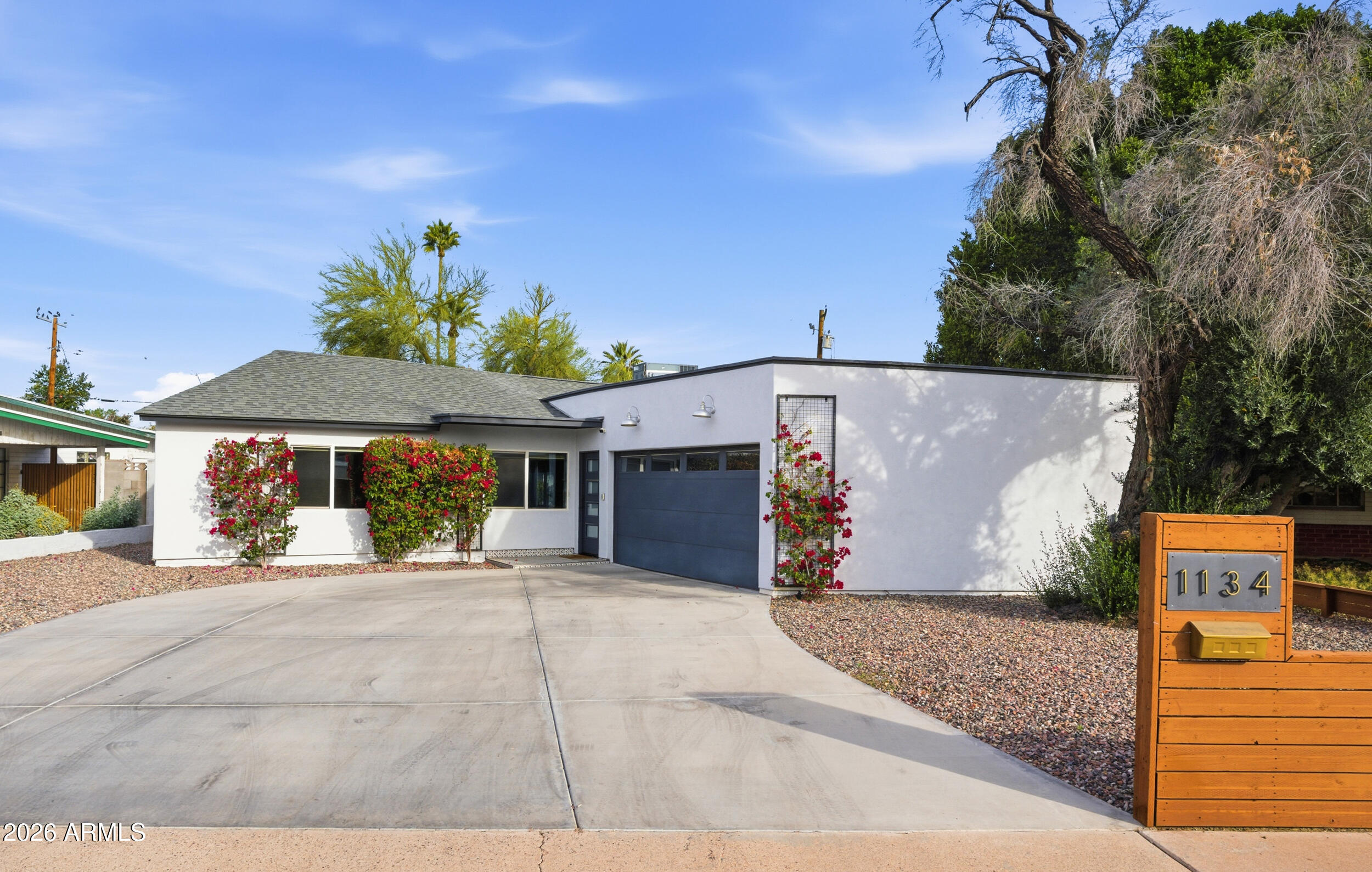 1134 East Colter Street Phoenix, AZ 85014 - Photo 1 of 27 a backyard of a house with table and chairs