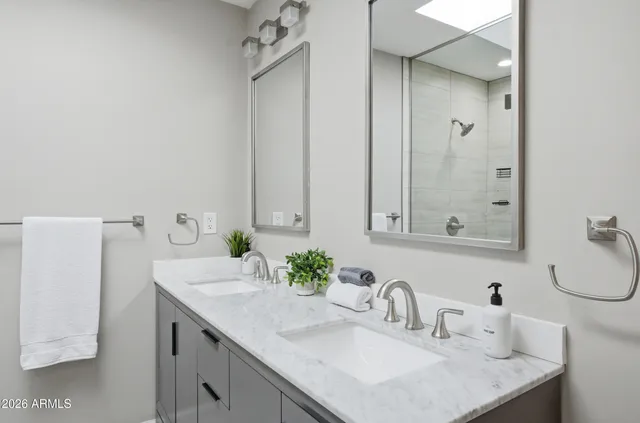 a bathroom with a sink vanity and a mirror