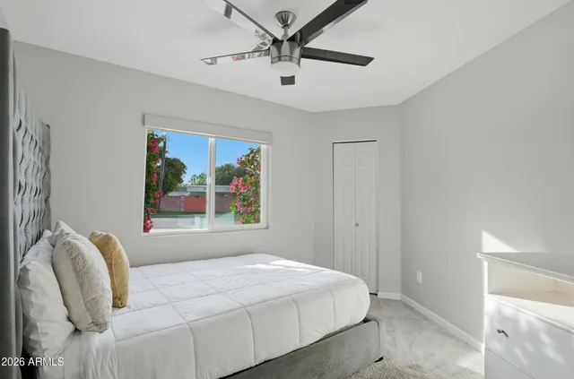 a bedroom with a bed and a painting on the wall