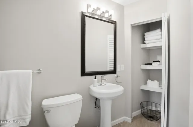 a bathroom with a sink toilet and mirror