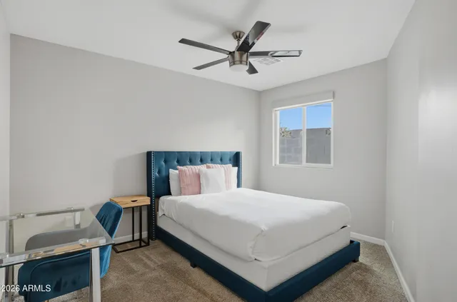 a bedroom with a bed and window