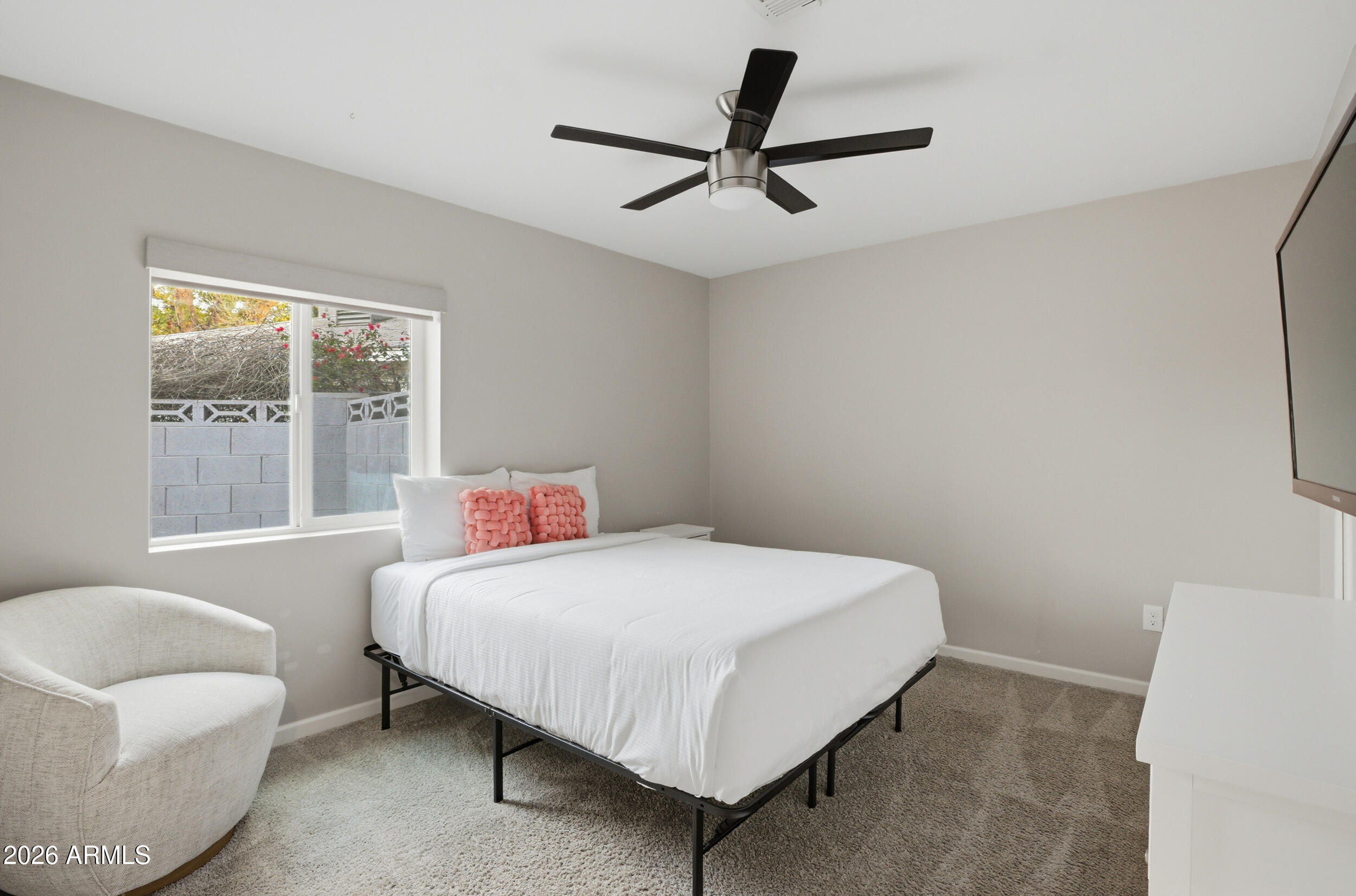 1134 East Colter Street Phoenix, AZ 85014 - Photo 20 of 27 a bedroom with a bed a couch and a window