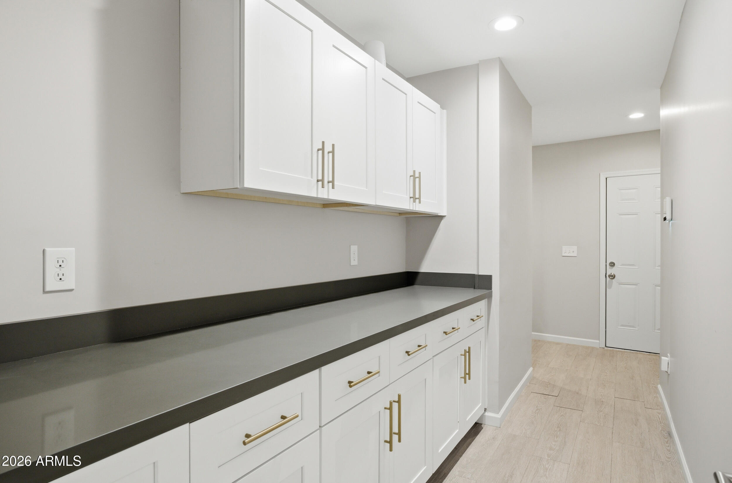 1134 East Colter Street Phoenix, AZ 85014 - Photo 21 of 27 a kitchen with granite countertop white cabinets and sink