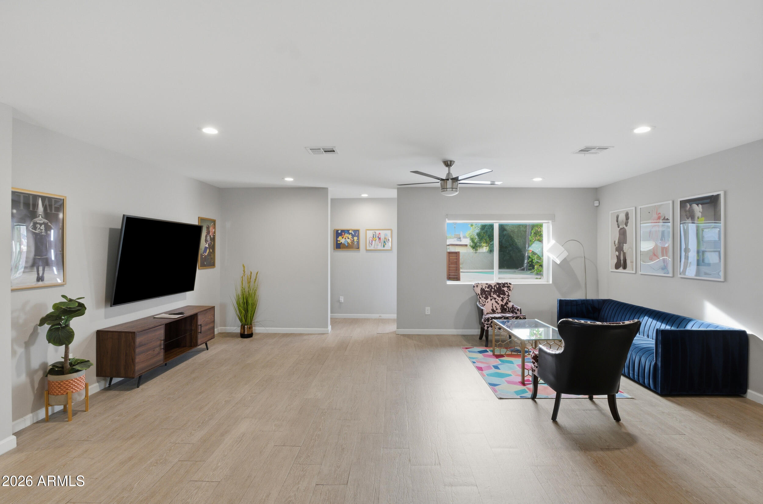 1134 East Colter Street Phoenix, AZ 85014 - Photo 3 of 27 a living room with furniture and a flat screen tv