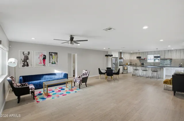 a living room with furniture and kitchen view