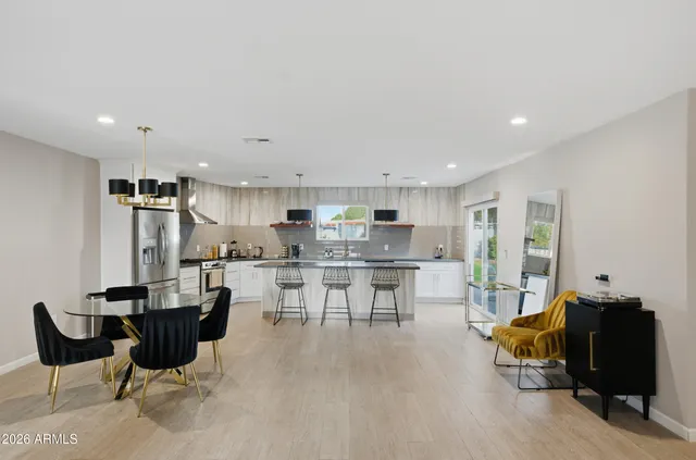 a living room with lots of furniture and kitchen view